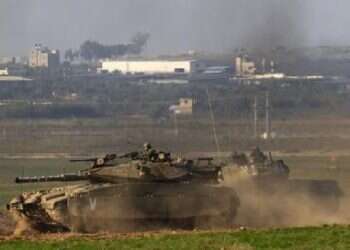 Israeli tanks maneuver near the Gaza Strip border