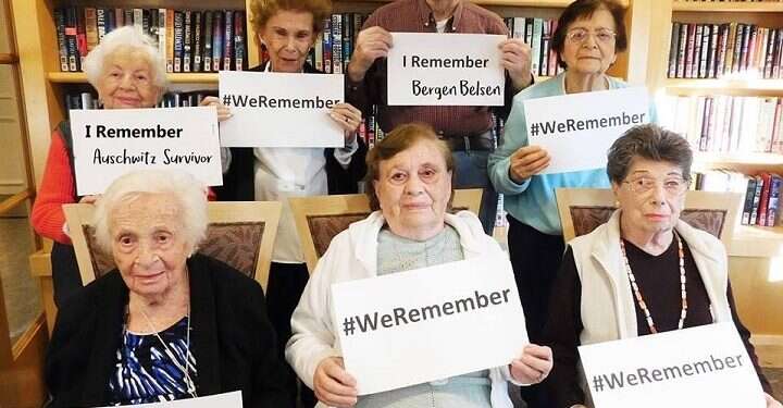 Holocaust survivors hold up the signs #WeRemember Holocaust memorial campaign spreads to 45 countries