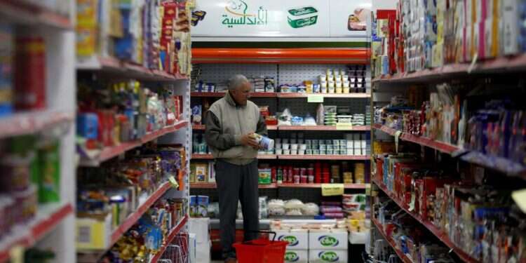 A Palestinian man shops at a supermarket in Gaza City Palestinian unity fails to offer Gazans expected relief
