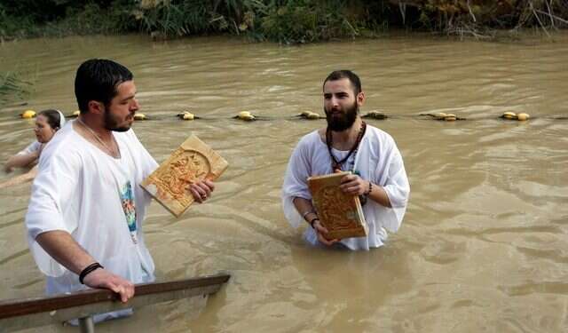 Orthodox Christians re-enact Jesus' baptism in Jordan River