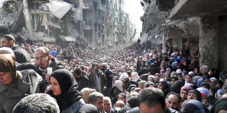Palestinian residents of the besieged Yarmouk Camp queue to receive food supplies A-list celebrities slam 'hurtful' Trump aid cuts to Palestinians