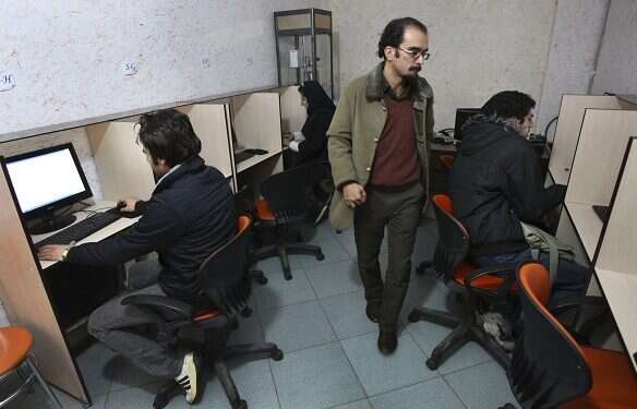 Iranians work in an internet cafe in central Tehran After unrest, Iran seeks control through 'halal' internet