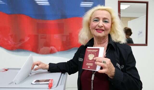 A voter at the Russian Embassy's Consular Section in Tel Aviv casting her ballot Russia needs 'a strong leader,' Israeli-Russians say at polling station