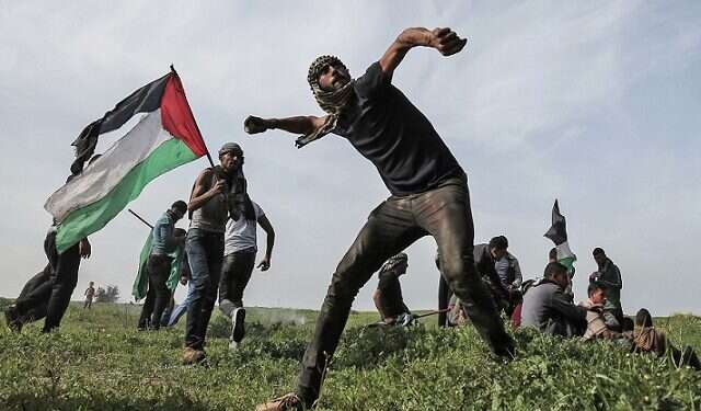 Palestinian protesters near the Israel-Gaza border Report: Israel, PA, Jordan, Egypt join forces to prevent Gaza march violence