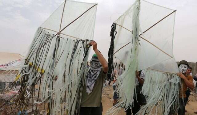 Palestinians prepare to send incendiary kites across the Israel-Gaza Strip IDF fires tear gas, warning shots at Palestinian rioters near Gaza border