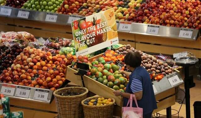 A woman browses the fruit section of a supermarket in Canada Minister lauds groundbreaking free trade deal between Israel, Canada