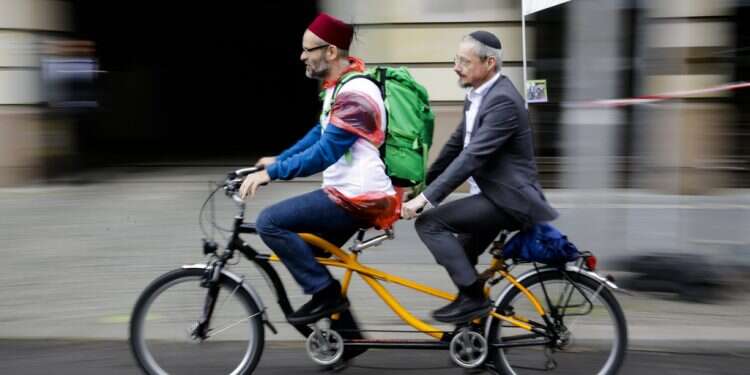 A Muslim man and a Jewish man ride in Berlin In Berlin, Jews and Muslims ride tandem bicycles to fight hatred