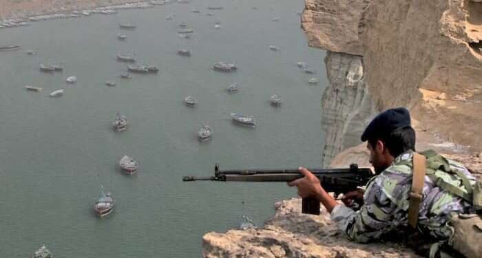 An Iranian solider positioned over the Strait of Hormuz US-Iran tensions rise over oil route as EU tries to save nuclear deal