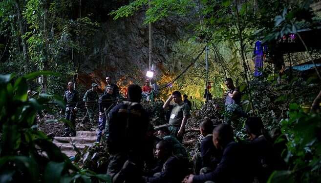Volunteer rescuer Rafael Aroush says he can dive and help interpret for foreign search-and-rescue teams|Rescue workers work next to water pumped out of the Tham Luang cave |Military personnel gather as they prepare to go in to Tham Luang cave complex ||