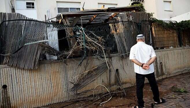 An man walks near the home of the Buchris family in Sderot 'They won't break us,' residents of Gaza-adjacent communities say
