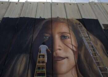 Italians arrested while painting West Bank mural of protest icon