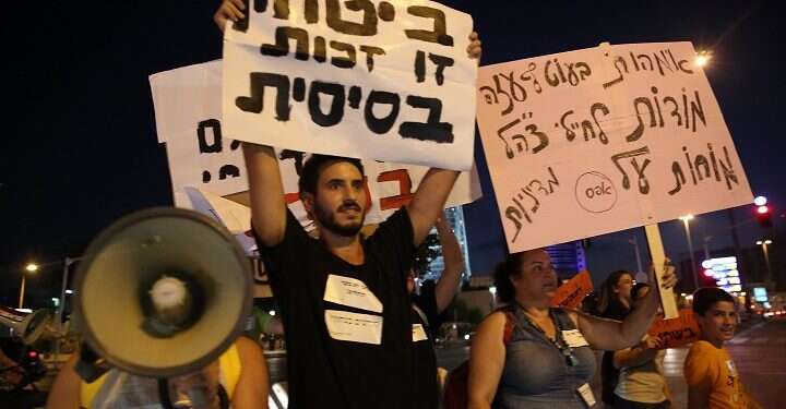 An IDF tank on the Israel-Gaza Strip border|A resident of southern Israel holding a sign reading. 'Security is a basic right' during a Tel Aviv protest |
