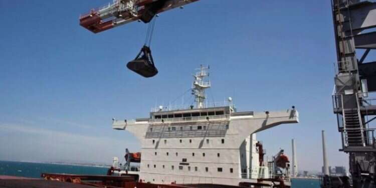 A crane unloads coal from a ship at the Israel Electric Corporation's Orot Rabin coal-fired power station near Hadera Israel to end use of coal for electricity production by 2030