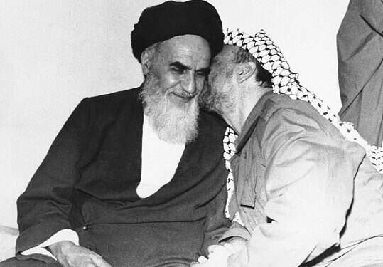 Demonstrators in Tehran hold a poster of Ayatollah Ruhollah Khomeini during a protest against the shah in 1979|Palestinian Liberation Organization leader Yasser Arafat |