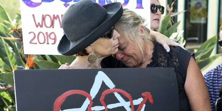 Leslie Gollub and Gretchen Gordon hug at a vigil for victims of Saturday's shooting at Chabad of Poway synagogue, Sunday Hundreds gather at vigil to honor synagogue attack victims