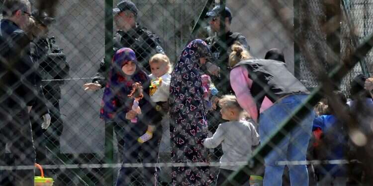 Police officers guard women and children related to Kosovo jihadists who returned from Syria, at a detention facility for foreigners in Pristina, Kosovo, Saturday Kosovo brings jihadist fighters and their families back from Syria