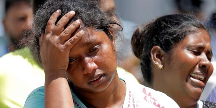 Relatives of victims react at a police mortuary 'Sri Lanka attacks perpetrated by local jihadists with backing from international network'
