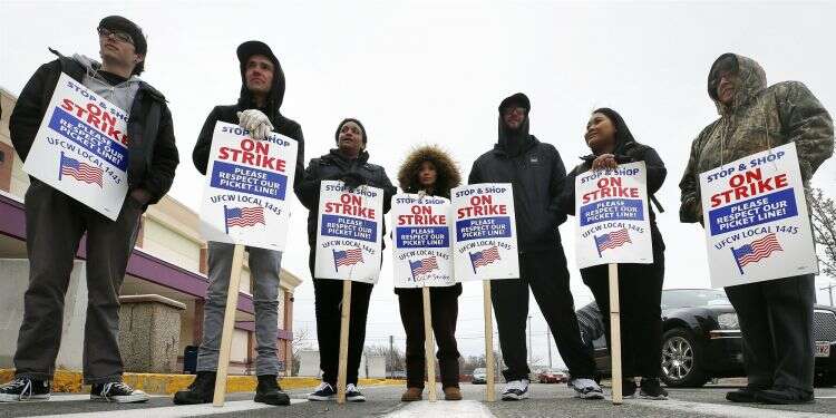 Striking workers stand on a picket line outside the Stop & Shop supermarket in Revere, Massachusetts, on April 18, 2019 Rabbis: 'Not kosher' to shop at supermarket during strike