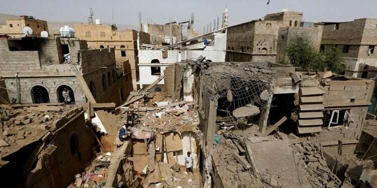 People check damage at the site of an airstrike in Amran, Yemen in June 2018 US House follows Senate, votes to end war in Yemen