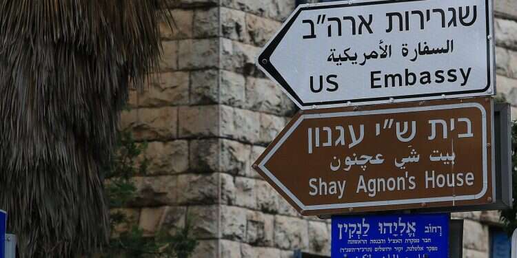 A sign in Hebrew, Arabic, and English points the way to the US Embassy in Jerusalem Palestinians seek UN court order to remove US Embassy from Jerusalem