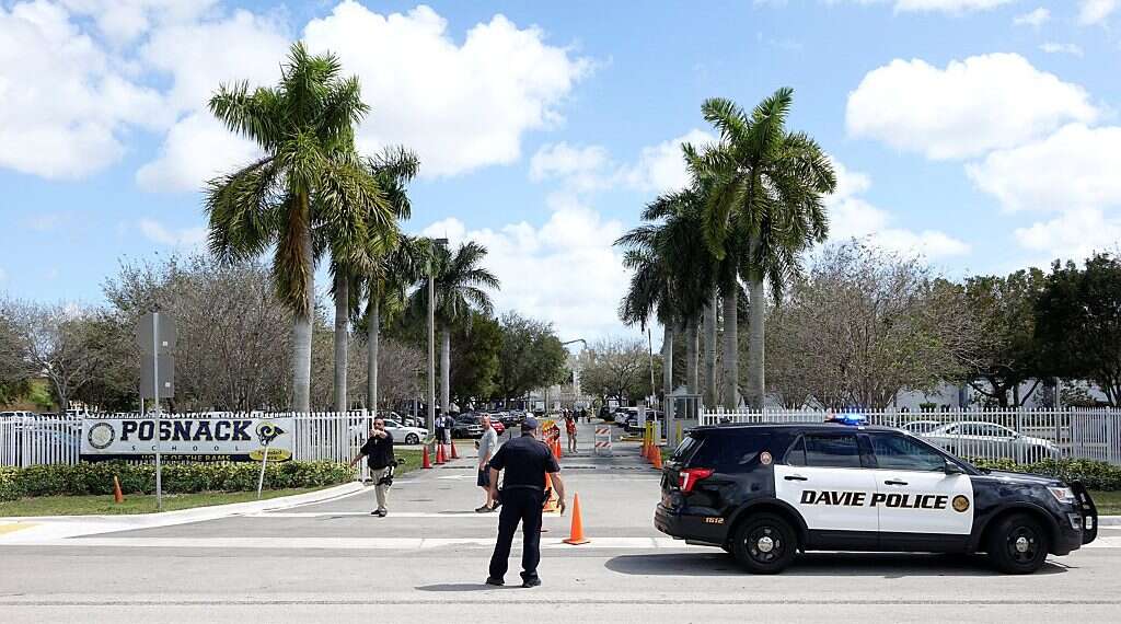Police vehicles are seen outside the David Posnack Jewish Day School after the second bomb threat in a month was reported in Davie, Florida, US March 7, 2017 Florida synagogue receives package with anti-Semitic content