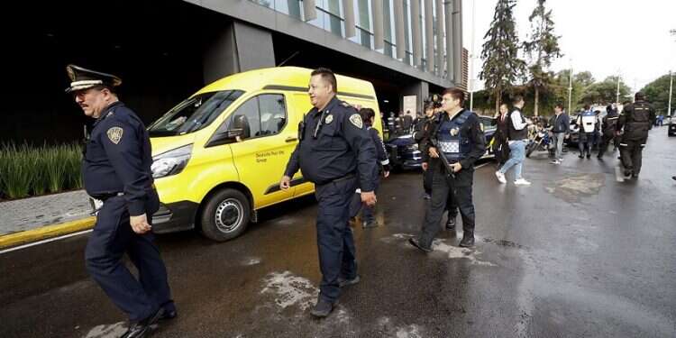 Police arrive at an upscale shopping mall in Mexico City, where two Israeli men were shot to death, Wednesday Mexico says killing of Israelis linked to drug cartels, money laundering