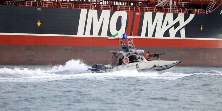 In this Sunday, July 21, photo, a speedboat of Iran's Revolutionary Guard moves around the British-flagged oil tanker Stena Impero, which was seized in the Strait of Hormuz on July 19 Britain: Iran must 'come out of the dark,' respect international law