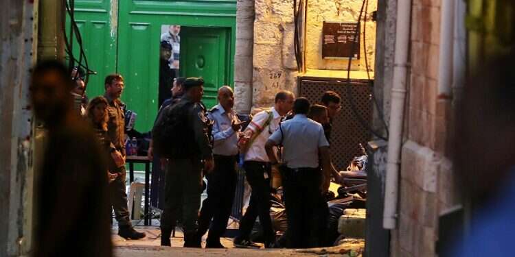 Policemen and rescue workers at the scene of Thursday's stabbing attack in Jerusalem's Old City Police officer wounded in J'lem stabbing; terrorist shot dead