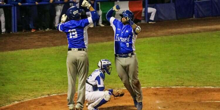 Israel national team players Danny Valencia (19) and Nick Rickles (9) celebrate on Sunday Israeli baseball makes history as team qualifies for Tokyo 2020