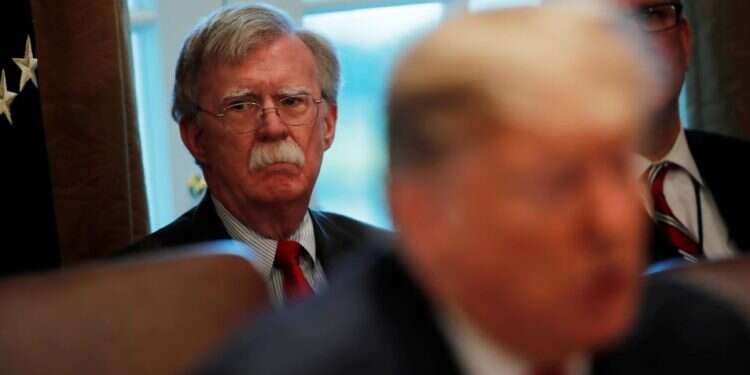 Then-White House National Security Adviser John Bolton listens as US President Donald Trump speaks at a cabinet meeting in February Trump fires foreign policy hawk Bolton, citing strong disagreements
