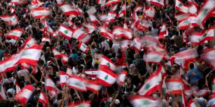 Demonstrators wave Lebanese national flags during ongoing anti-government protests at a highway in Jal el-Dib Lebanon's protesters turn on their leaders, breaking taboos