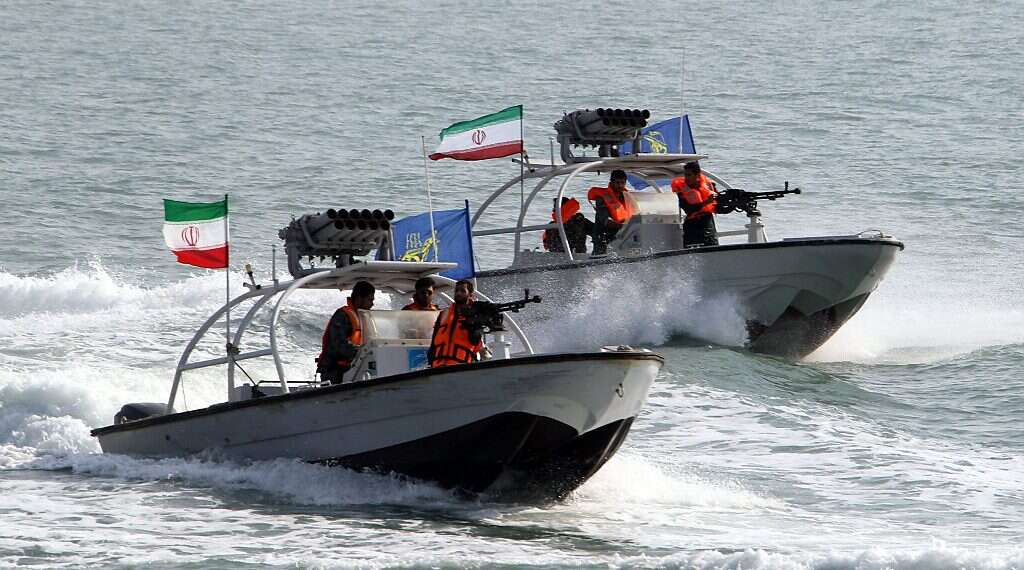 Iranian Revolutionary Guards drive speedboats at the port of Bandar Abbas Iranian ship sanctioned by US docks in Syrian port