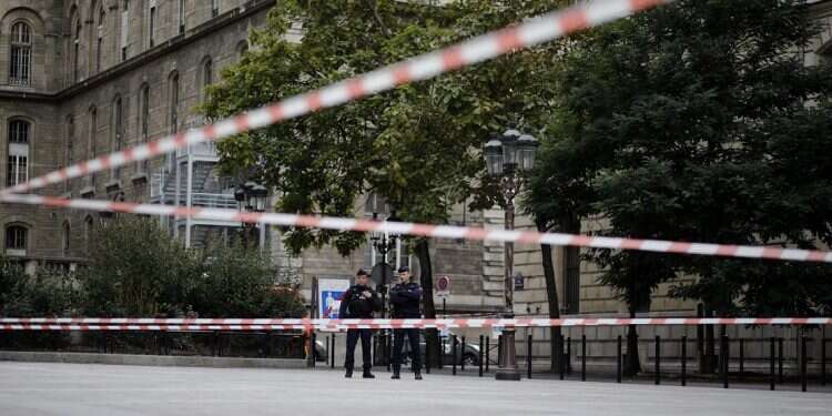 Police officers stand guard outside the Paris police headquarters, Thursday 'Recent convert to Islam' stabs 4 to death at Paris police headquarters