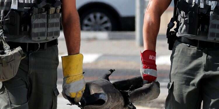 Israeli sappers carry the remains of a rocket in Kiryat Gat, southern Israel Tuesday Rocket salvo fired at southern Israel as tensions with Gaza rise