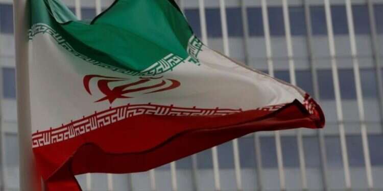 An Iranian flag flutters in front of the International Atomic Energy Agency headquarters in Vienna, Austria Iran rejects IAEA findings of traces of uranium at unnamed site