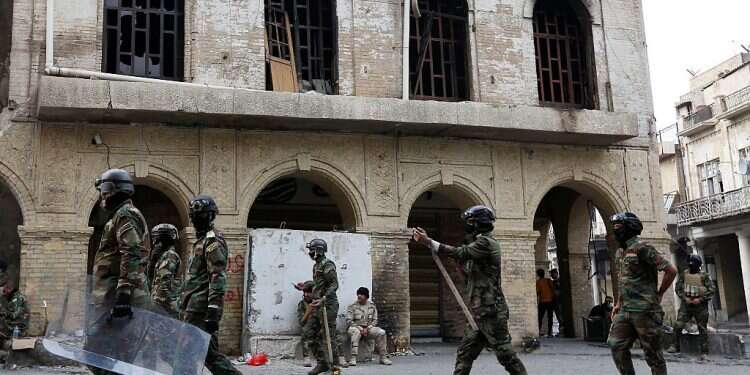 Iraq protesters burn shrine entrance in holy city, say PM quitting 'not enough'