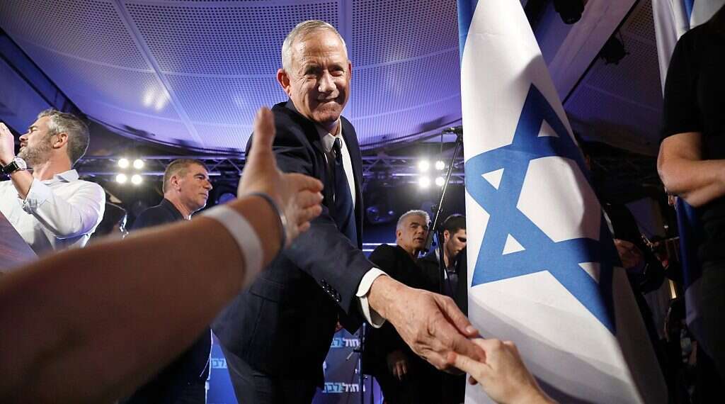 Blue and White leader Benny Gantz shakes hands with activists at a party event Left-wing bloc surges to 60 seats in new poll
