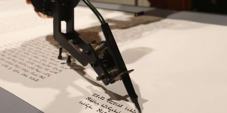 A robot writes a Torah scroll at an installation in the Jewish Museum in Berlin, Germany, July 10, 2014 Are robots the Torah scribes of the future?