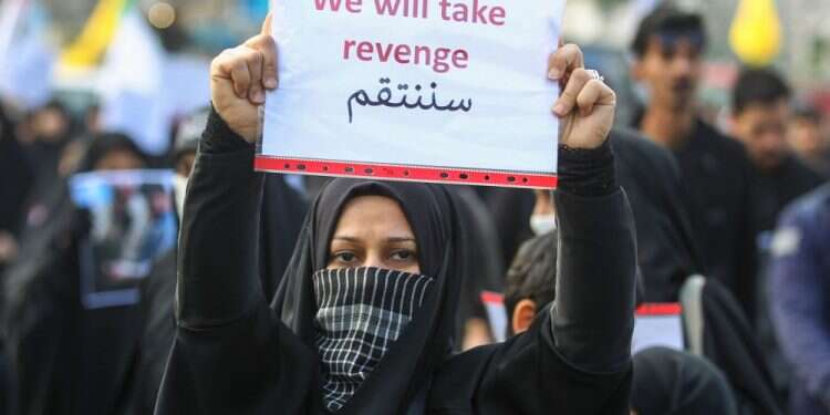 An Iraqi woman during the funeral of Iranian military commander Qasem Soleimani in Baghdad's high-security Green Zone Several wounded in rocket attack near US Embassy in Iraq