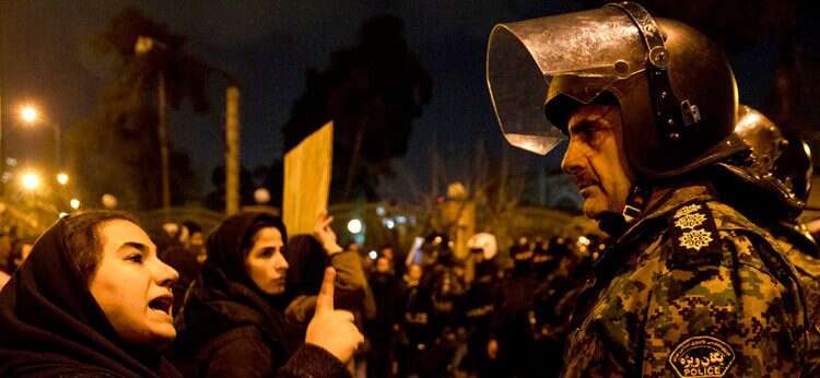 A woman attending a candlelight vigil to remember the victims of the Ukraine plane crash UK and Germany condemn arrest of Britain's Tehran ambassador