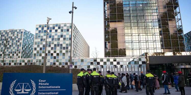 Police escorts a group of supporters of former Ivory Coast president Laurent Gbagbo outside the International Criminal Court in The Hague, Netherlands, Thursday, Feb. 6, 2020 Will anti-Israel case go unanswered at The Hague? Israeli lawyers already have a plan