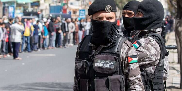 Jordanian security forces keep watch as people wait in queue for government bread delivery in Amman, Jordan Arab states fear corona will lead to chaos, anarchy