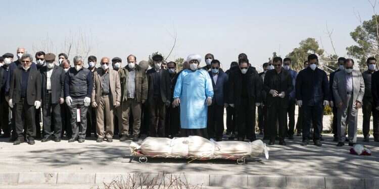 Mourners wearing face masks and gloves pray over the body of a former politburo official in the Revolutionary Guard who died last week after being infected with the coronavirus Jordan bars entry from West Bank, Israel, Iraq, Egypt