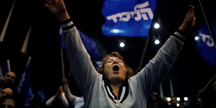 A supporter reacts following the announcement of exit polls at Prime Minister Benjamin Netanyahu's Likud party headquarters in Tel Aviv, Monday A case of 'divine intervention'?