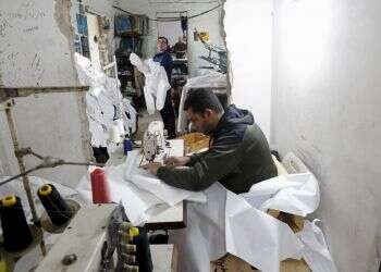 Gaza factories roar back to life to make protective wear