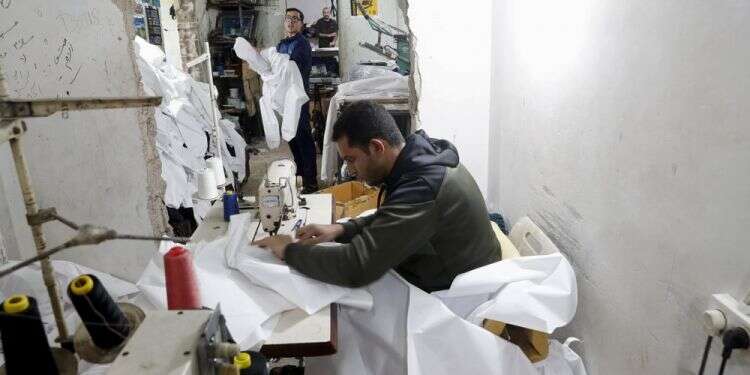 Gaza factories roar back to life to make protective wear