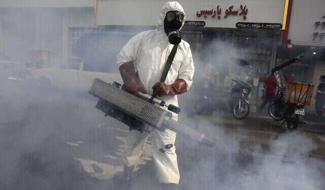 A firefighter disinfects a square against the new coronavirus, in western Tehran, Iran Coronavirus and the campaign against Iran