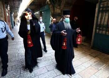 Holy Fire lit as Orthodox Easter bells echo over near-empty Jerusalem