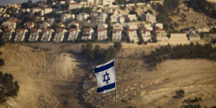 An Israeli flag is seen near the Jerusalem suburb of Maaleh Adumim US officials frustrated over settler leaders' opposition to Trump's peace plan
