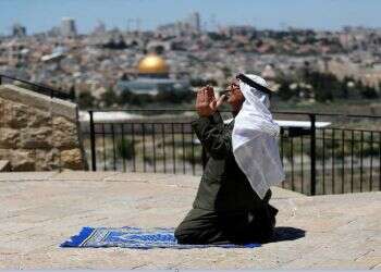 A Muslim worshipper prays outside Jerusalem's Old City amid the coronavirus restrictions, May 8, 2020 'Arabs, not Jews, founded and built Jerusalem'